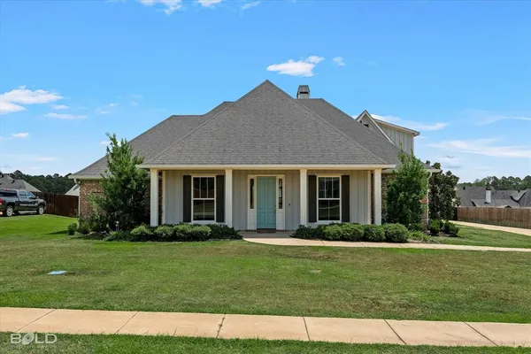 a front view of a house with a garden