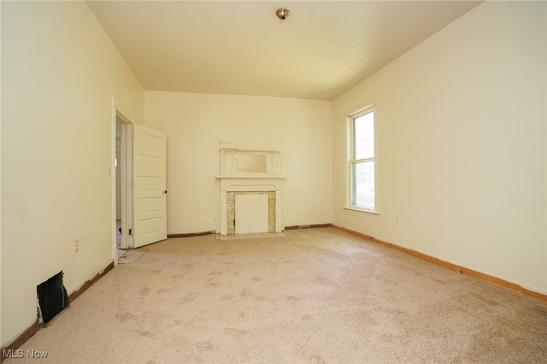 1720 Jacobs Road Youngstown, OH 44505 - Photo 12 of 18 Unfurnished living room with carpet flooring and baseboards