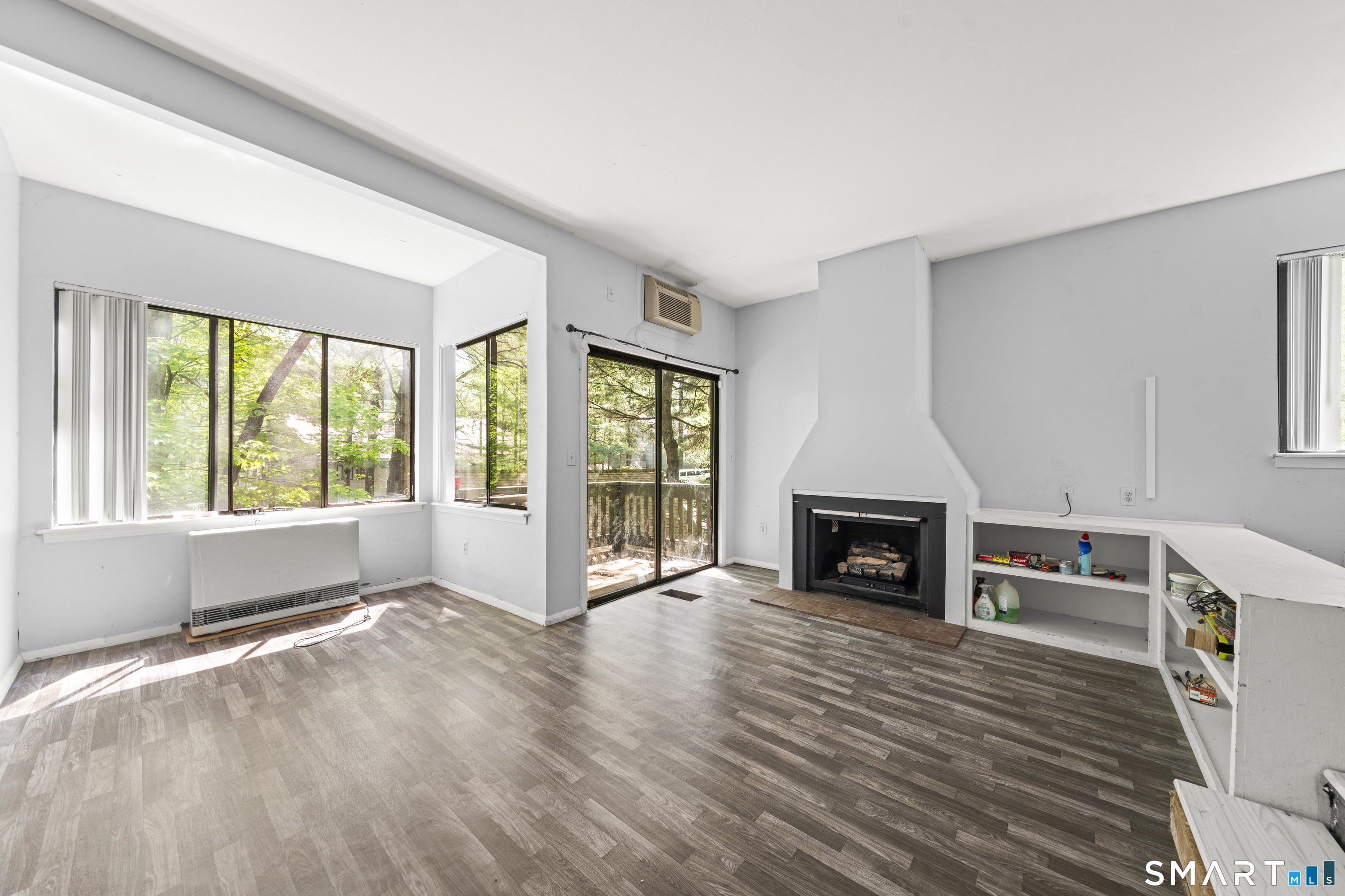 39 Evergreen Road, Unit 39 Torrington, CT 06790 - Photo 6 of 27 a view of a livingroom with a fireplace wooden floor and window
