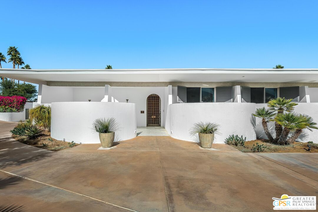 70378 Pecos Road Rancho Mirage, CA 92270 - Photo 1 of 1 a front view of a house with potted plants