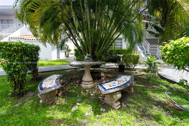 a swimming pool with outdoor seating and yard