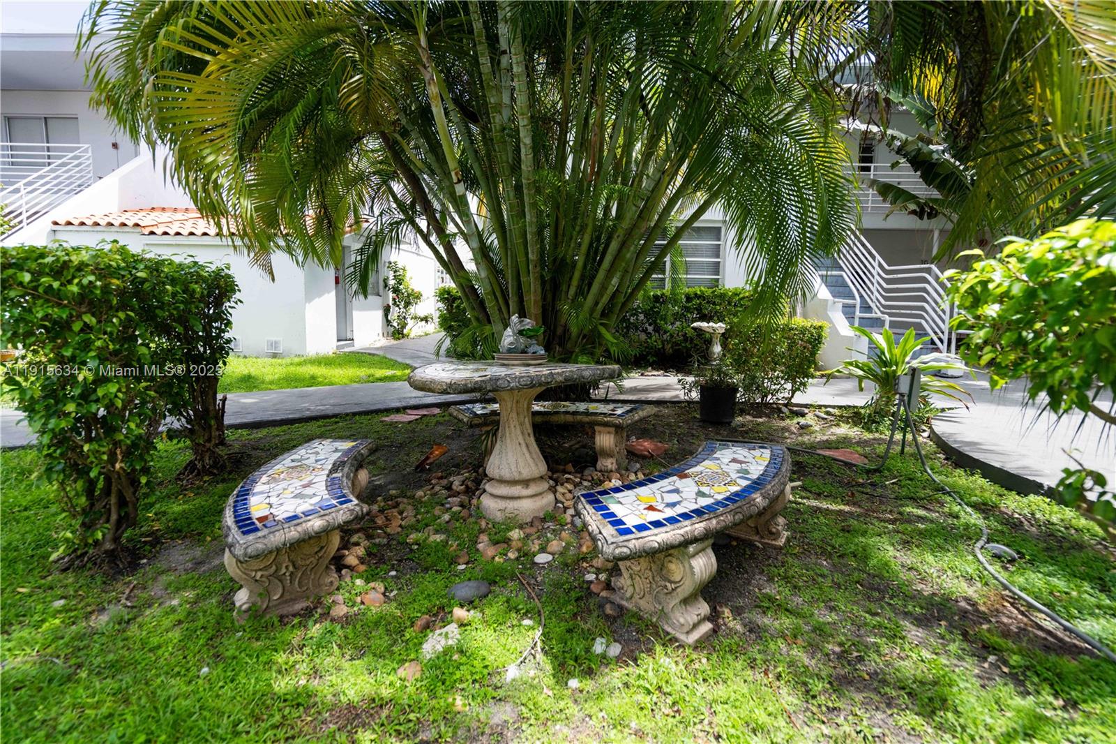 8315 Byron Avenue, Unit 2A Miami Beach, FL 33141 - Photo 11 of 13 a swimming pool with outdoor seating and yard