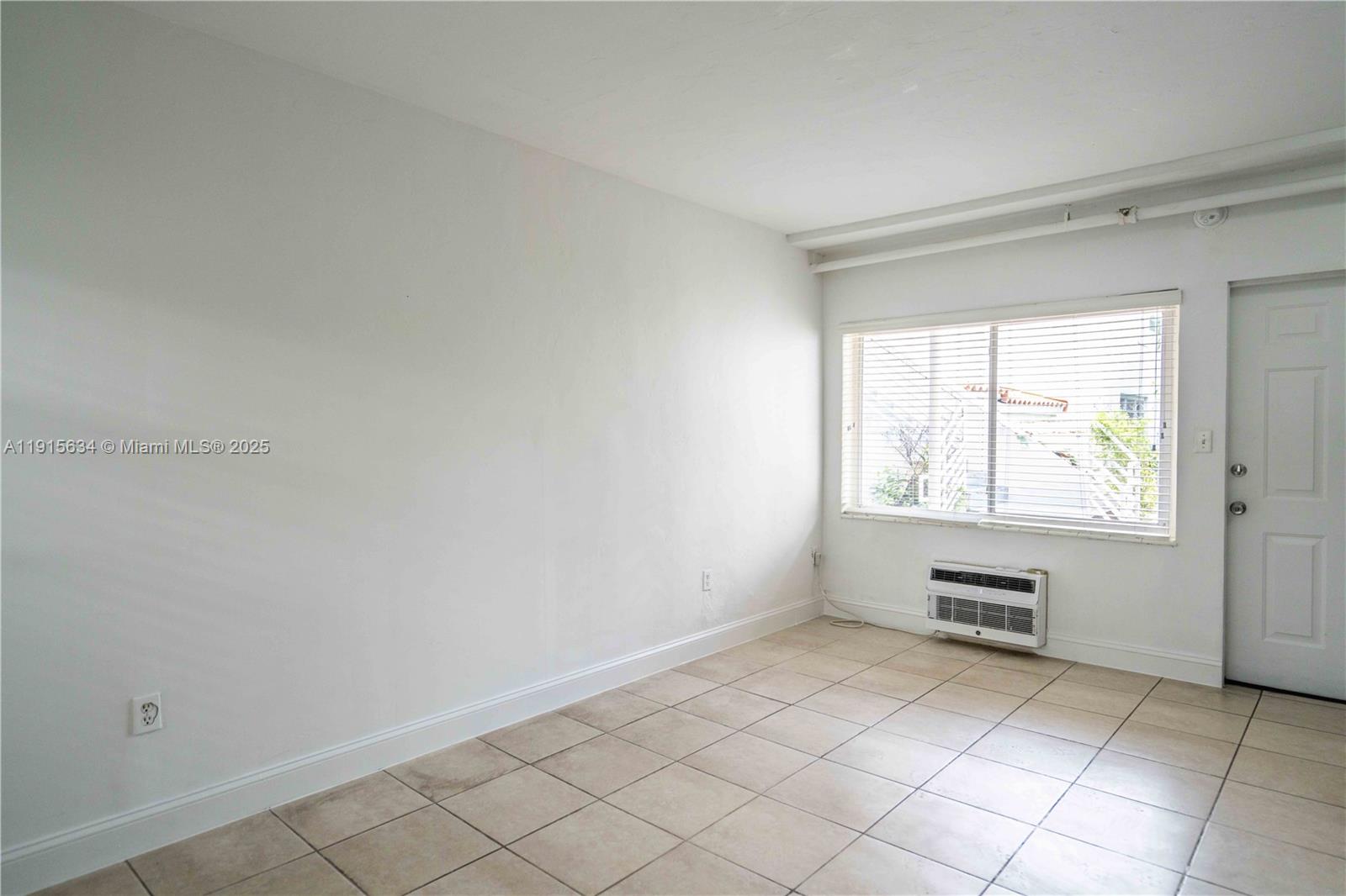 8315 Byron Avenue, Unit 2A Miami Beach, FL 33141 - Photo 2 of 13 an empty room with windows