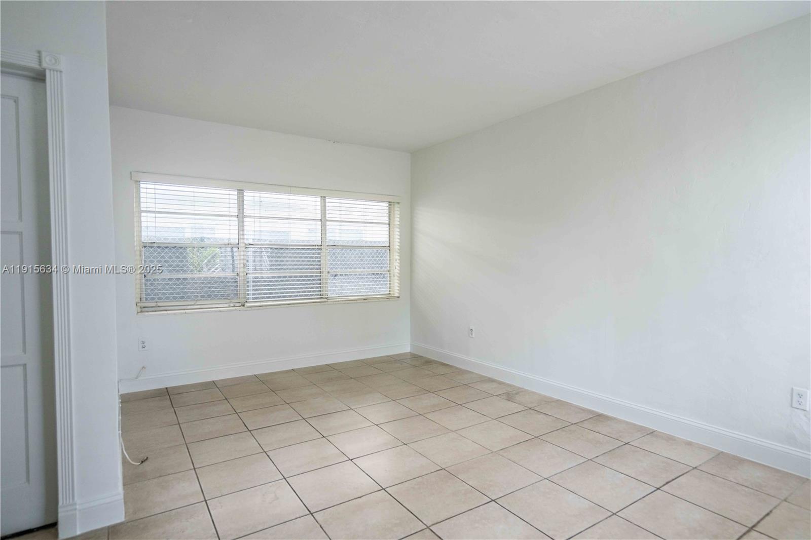 8315 Byron Avenue, Unit 2A Miami Beach, FL 33141 - Photo 5 of 13 a view of an empty room with a window