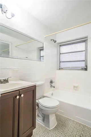 a bathroom with a toilet a sink and bathtub