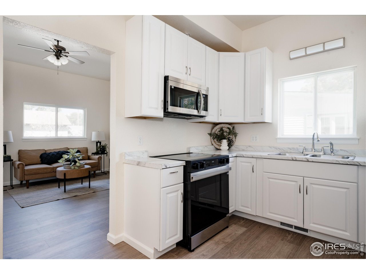 934 6th Street Berthoud, CO 80513 - Photo 11 of 28 a kitchen with stainless steel appliances granite countertop a stove a sink and a microwave