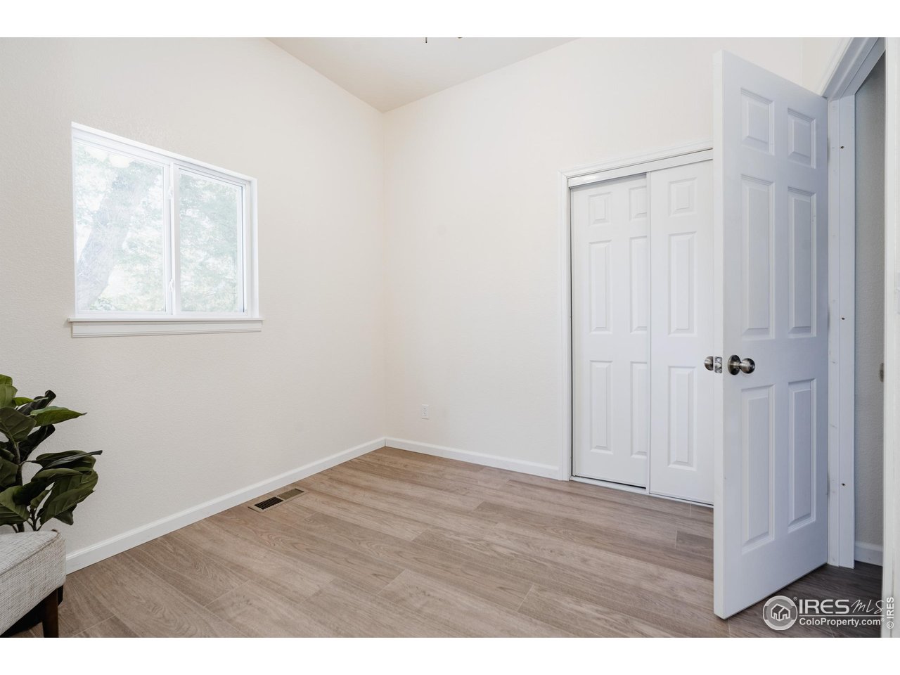934 6th Street Berthoud, CO 80513 - Photo 15 of 28 a view of an empty room with wooden floor