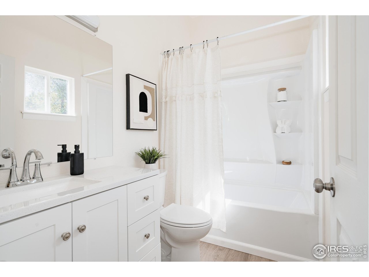 934 6th Street Berthoud, CO 80513 - Photo 16 of 28 a bathroom with a sink a toilet and shower
