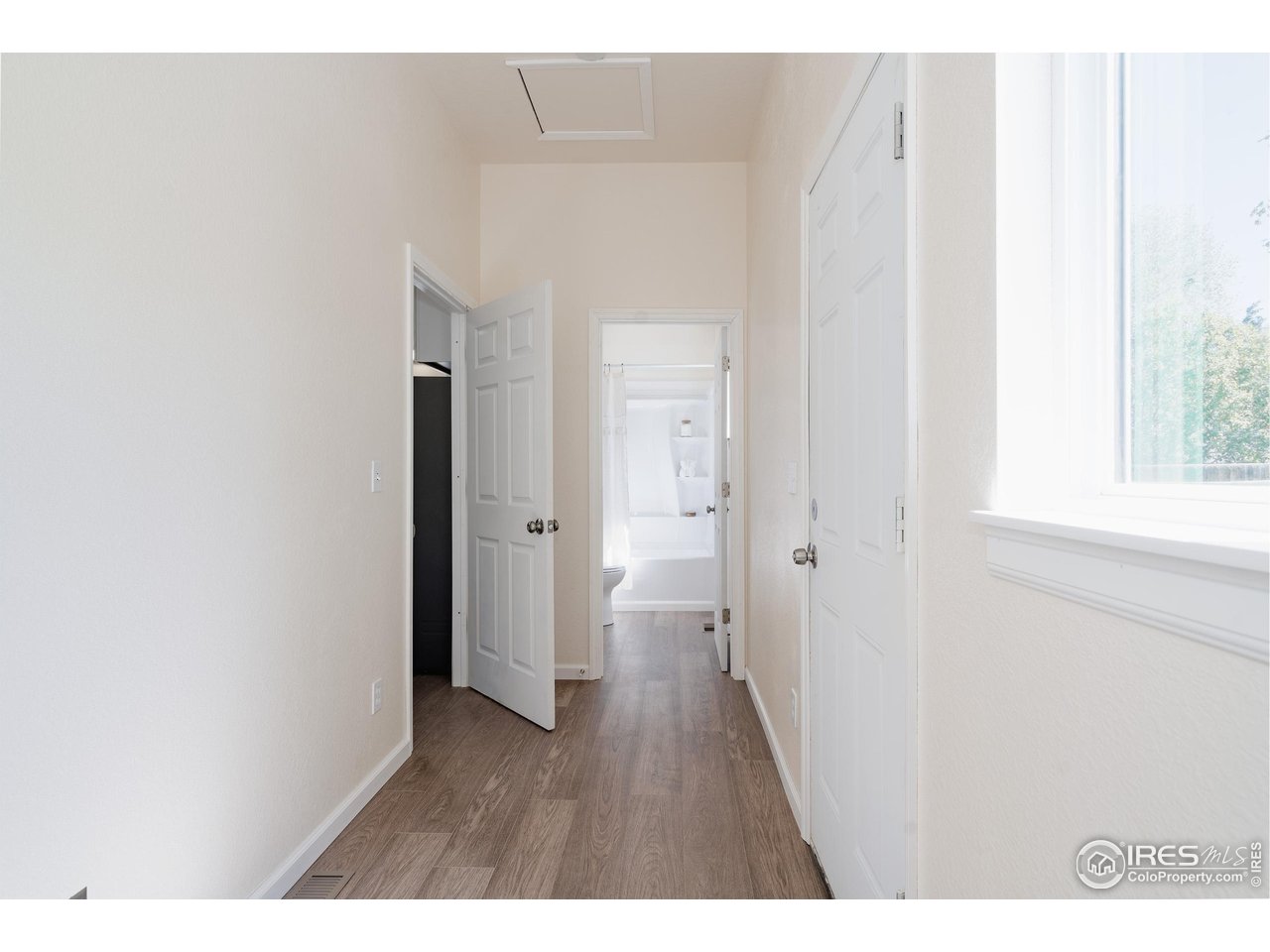 934 6th Street Berthoud, CO 80513 - Photo 17 of 28 a hallway with wooden floor closet and front door