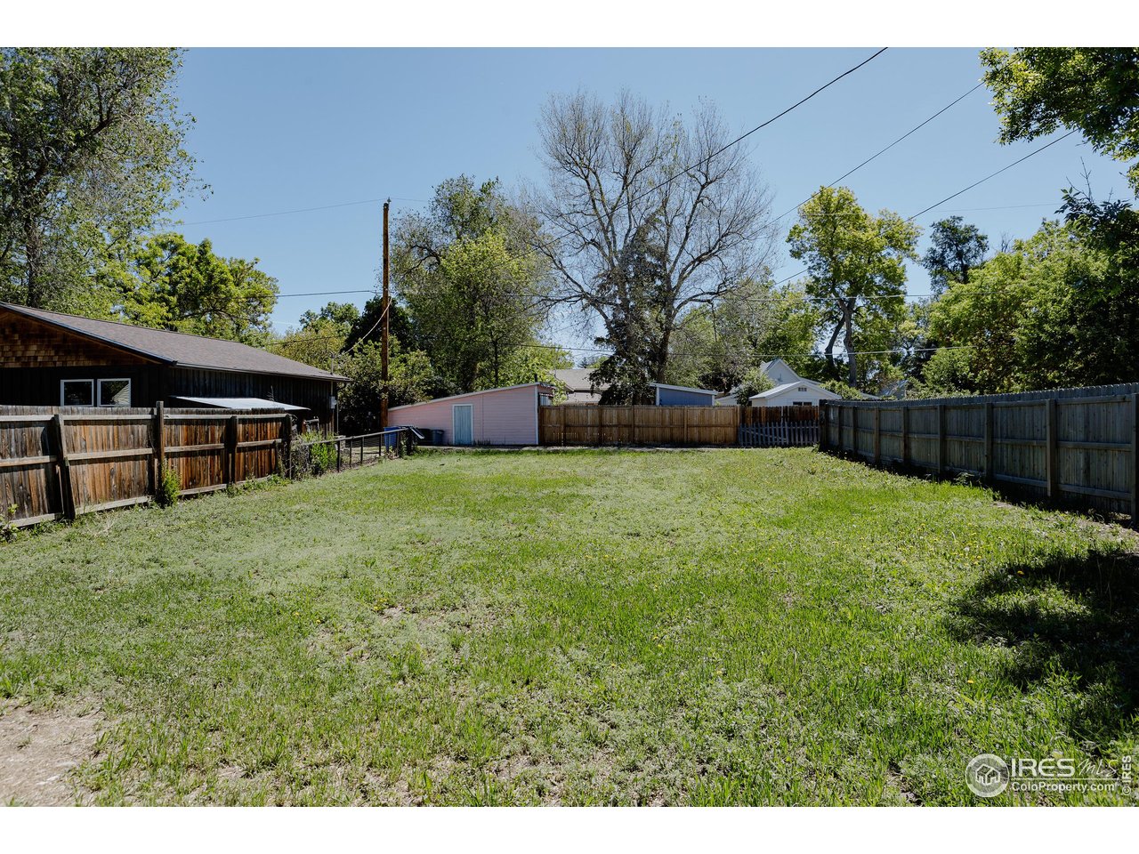934 6th Street Berthoud, CO 80513 - Photo 23 of 28 a view of a backyard with a garden and trees