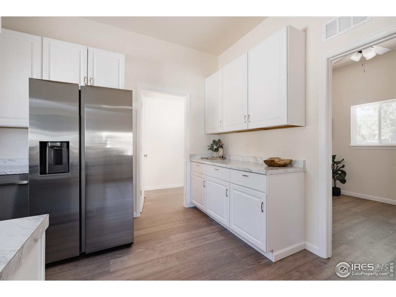 934 6th Street Berthoud, CO 80513 - Photo 6 of 28 a kitchen with stainless steel appliances kitchen island a refrigerator sink and cabinets