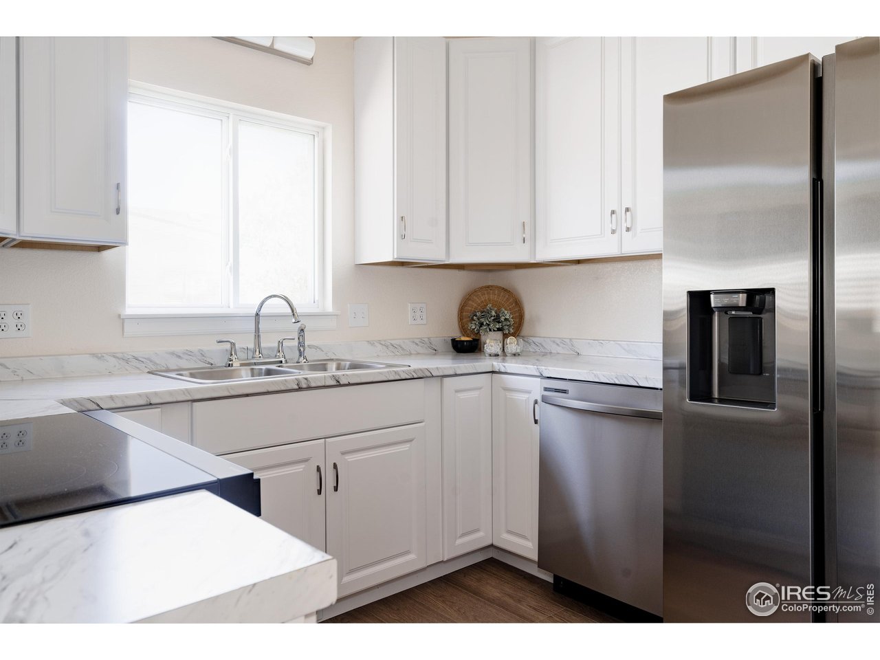 934 6th Street Berthoud, CO 80513 - Photo 7 of 28 a kitchen with a sink cabinets and stainless steel appliances