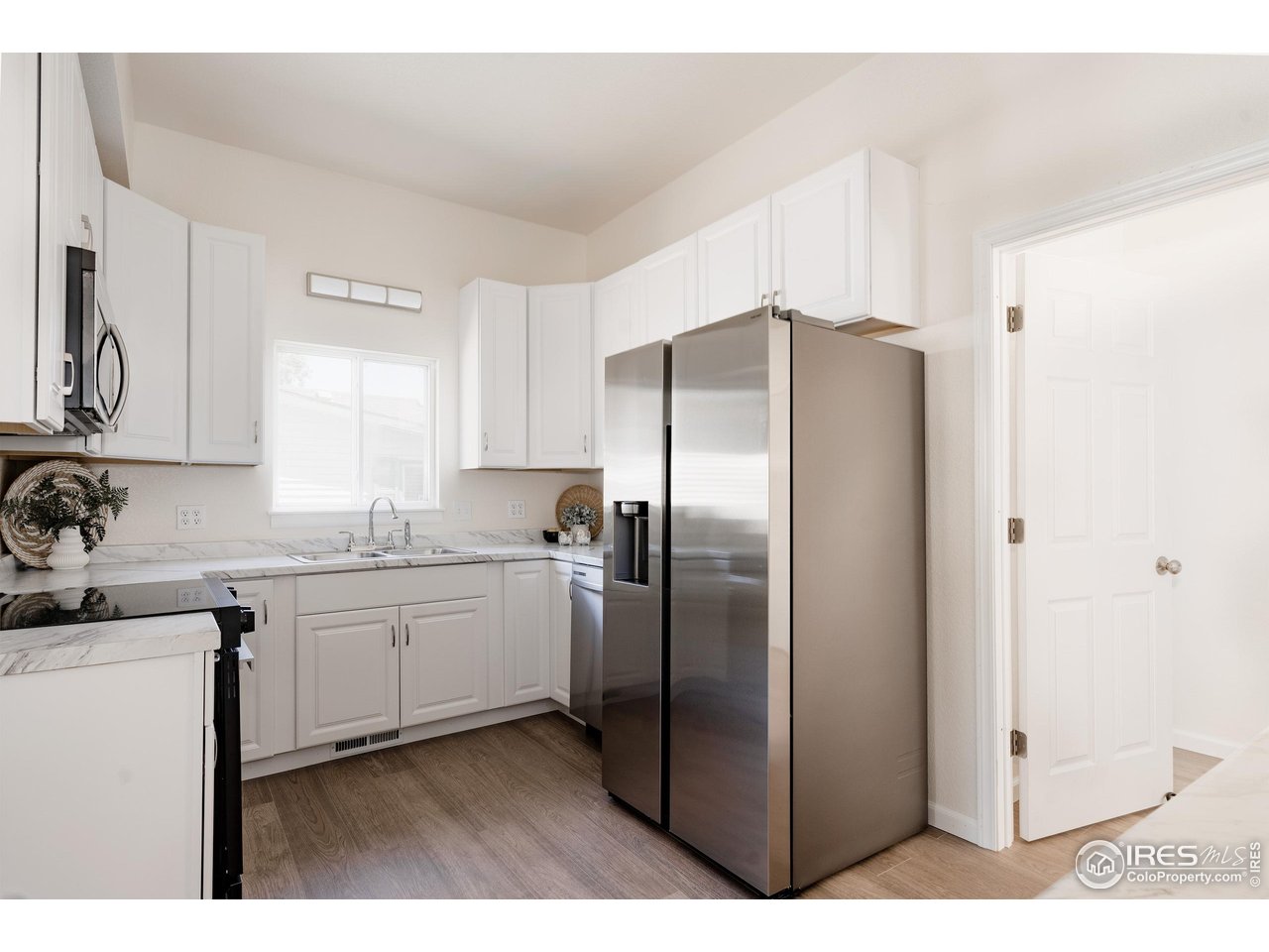 934 6th Street Berthoud, CO 80513 - Photo 9 of 28 a kitchen with stainless steel appliances granite countertop a refrigerator and a sink