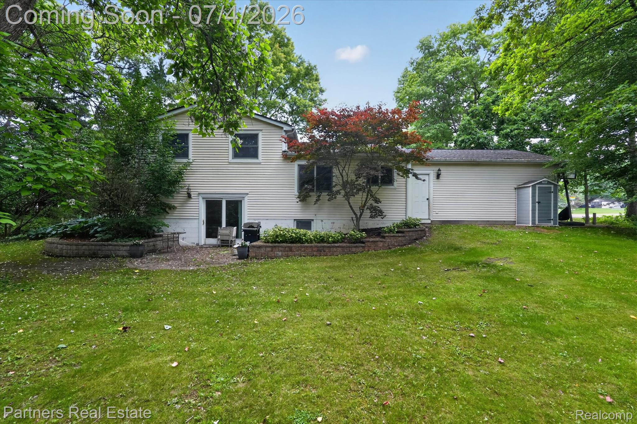 2500 Hubert Road Brighton, MI 48114 - Photo 38 of 53 Expansive rear lawn featuring mature trees and a dedicated patio area