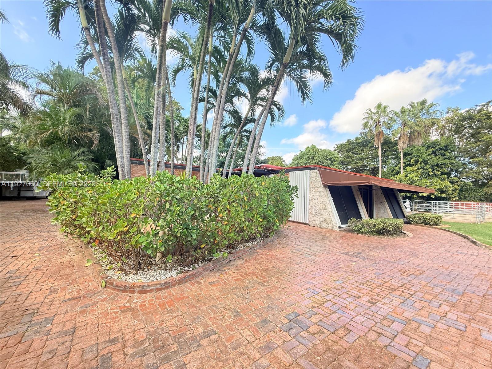 5877 Southwest 123rd Avenue, Unit MAIN Miami, FL 33183 - Photo 18 of 34 a view of backyard with outdoor seating and green space