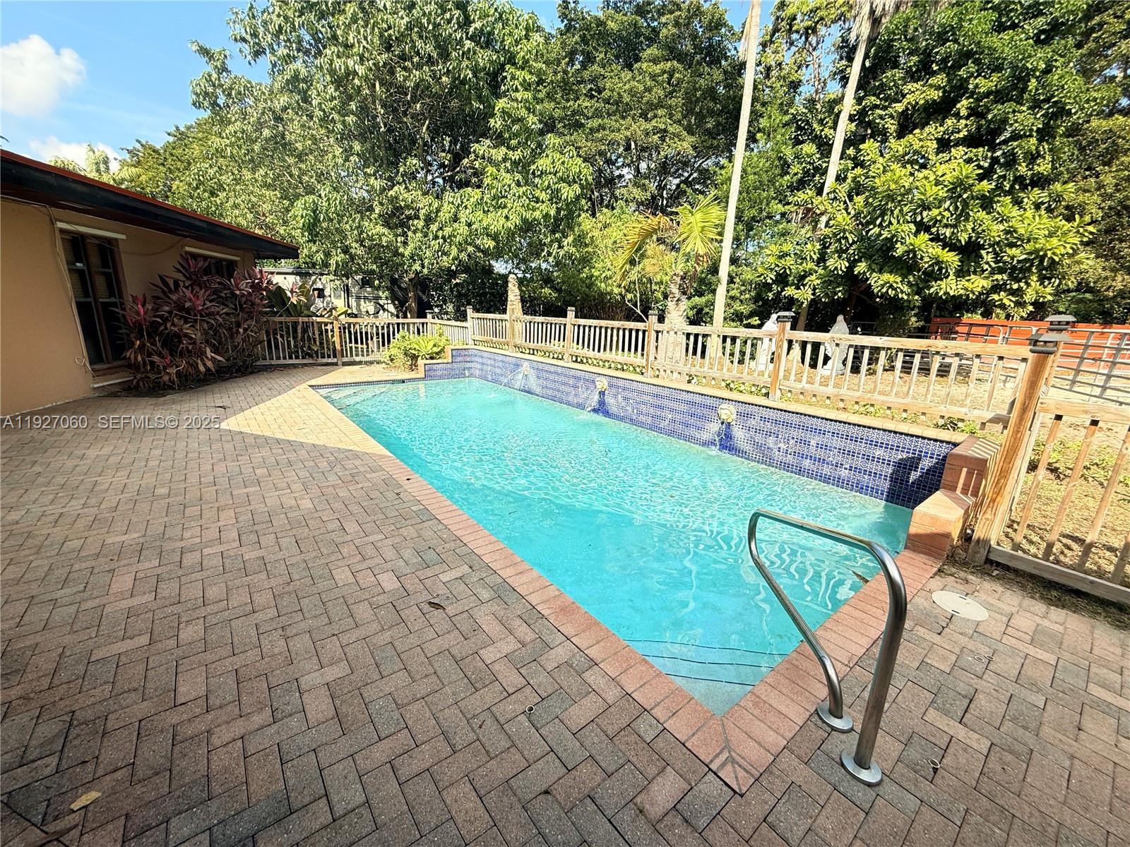 5877 Southwest 123rd Avenue, Unit MAIN Miami, FL 33183 - Photo 20 of 34 a view of a swimming pool with an outdoor seating