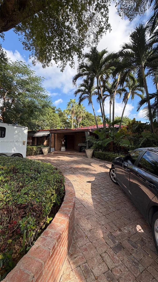5877 Southwest 123rd Avenue, Unit MAIN Miami, FL 33183 - Photo 2 of 34 a view of a yard and car parked