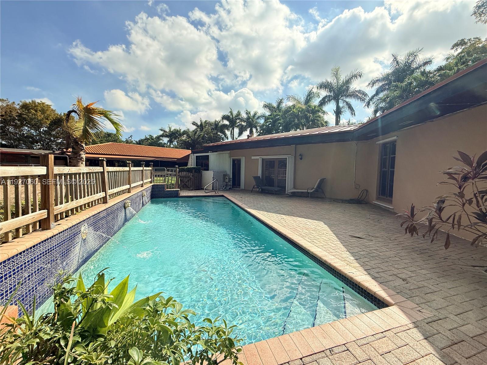 5877 Southwest 123rd Avenue, Unit MAIN Miami, FL 33183 - Photo 21 of 34 a view of a house with wooden deck and a backyard