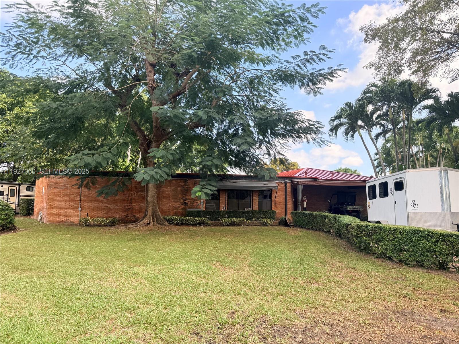 5877 Southwest 123rd Avenue, Unit MAIN Miami, FL 33183 - Photo 25 of 34 a view of a house with a yard and sitting area