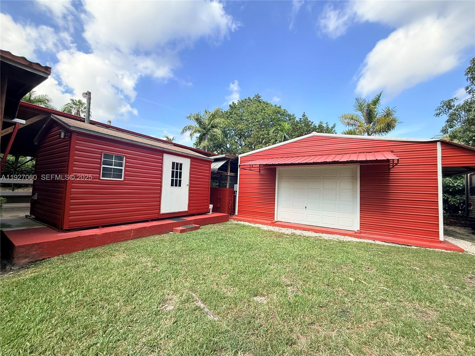 5877 Southwest 123rd Avenue, Unit MAIN Miami, FL 33183 - Photo 27 of 34 a front view of a house with a yard and garage
