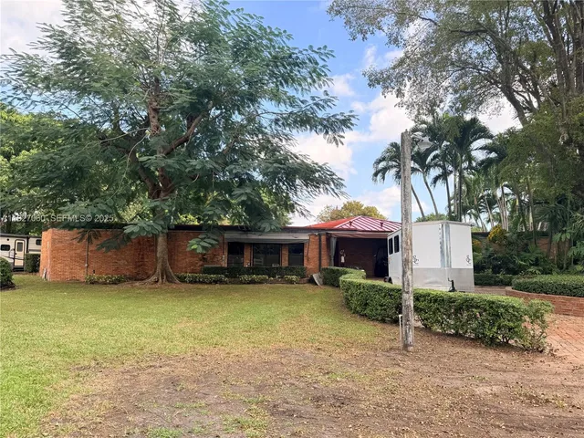 an aerial view of a house with swimming pool and garden