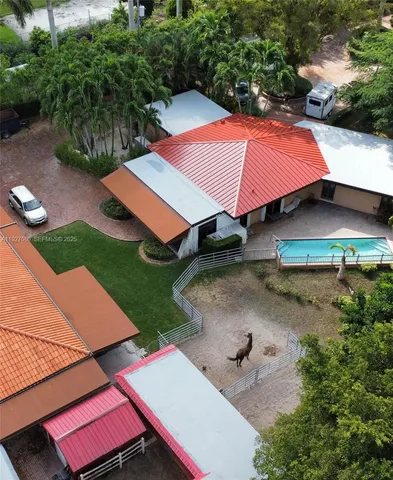 an aerial view of residential house with outdoor space and swimming pool