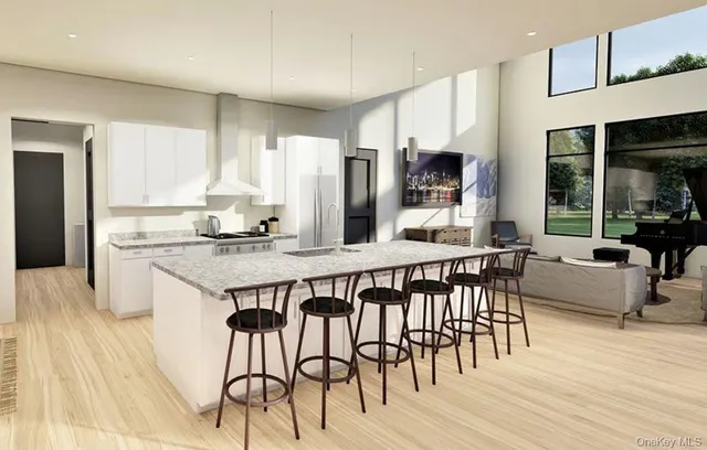 a kitchen with stainless steel appliances granite countertop a stove a sink dishwasher and a refrigerator with wooden floor