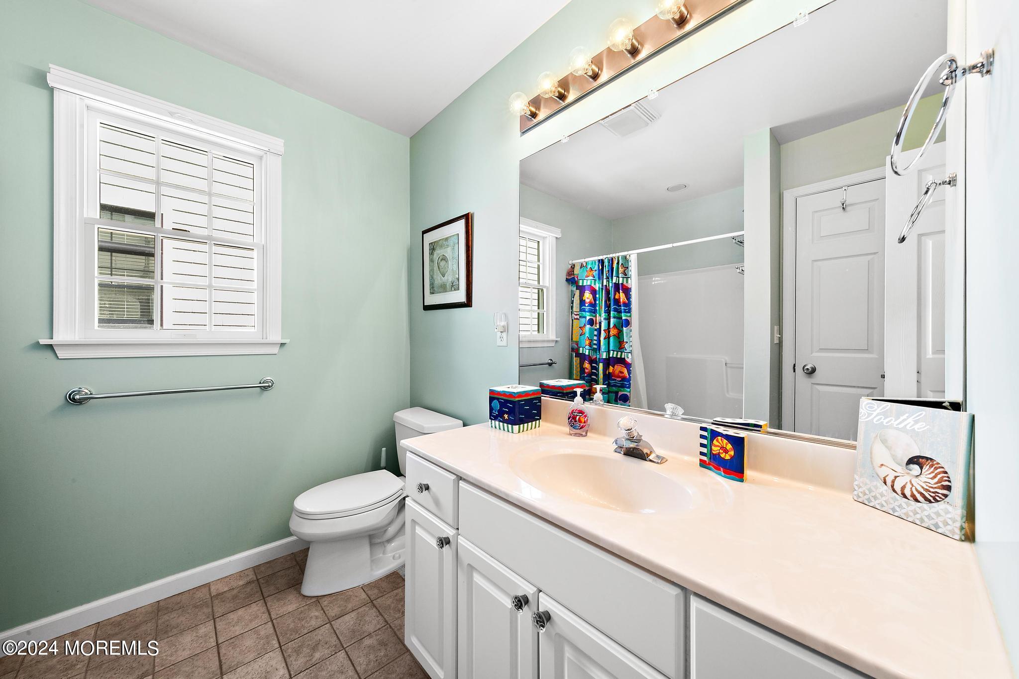 10 Arnold Boulevard Beach Haven, NJ 08008 - Photo 23 of 81 a bathroom with a sink a toilet and a mirror
