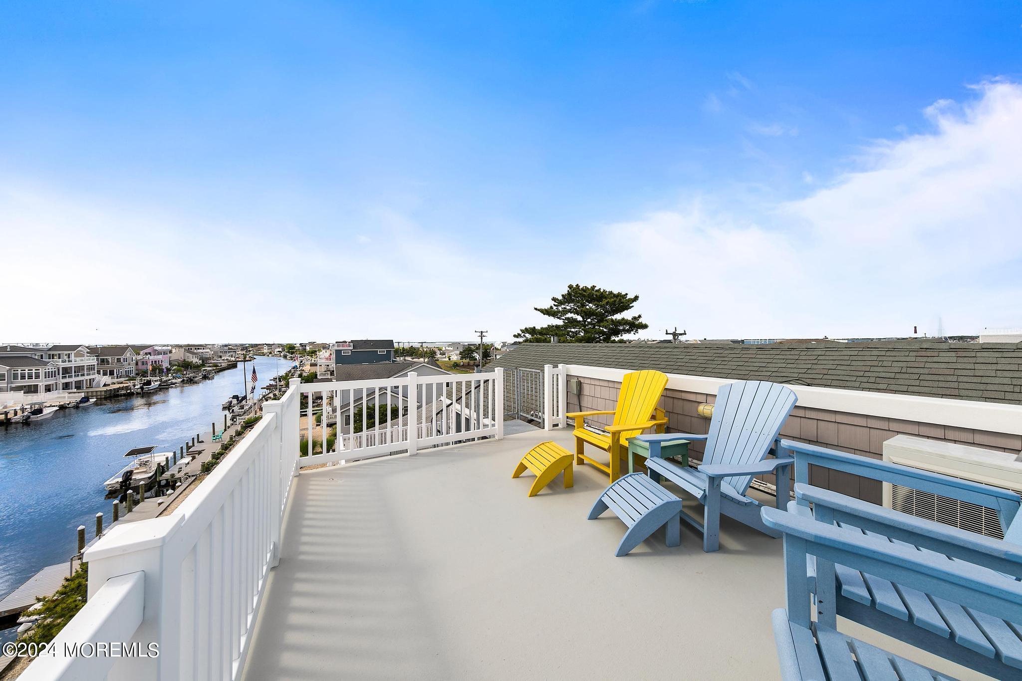 10 Arnold Boulevard Beach Haven, NJ 08008 - Photo 43 of 81 a view of a terrace with two chairs and a table
