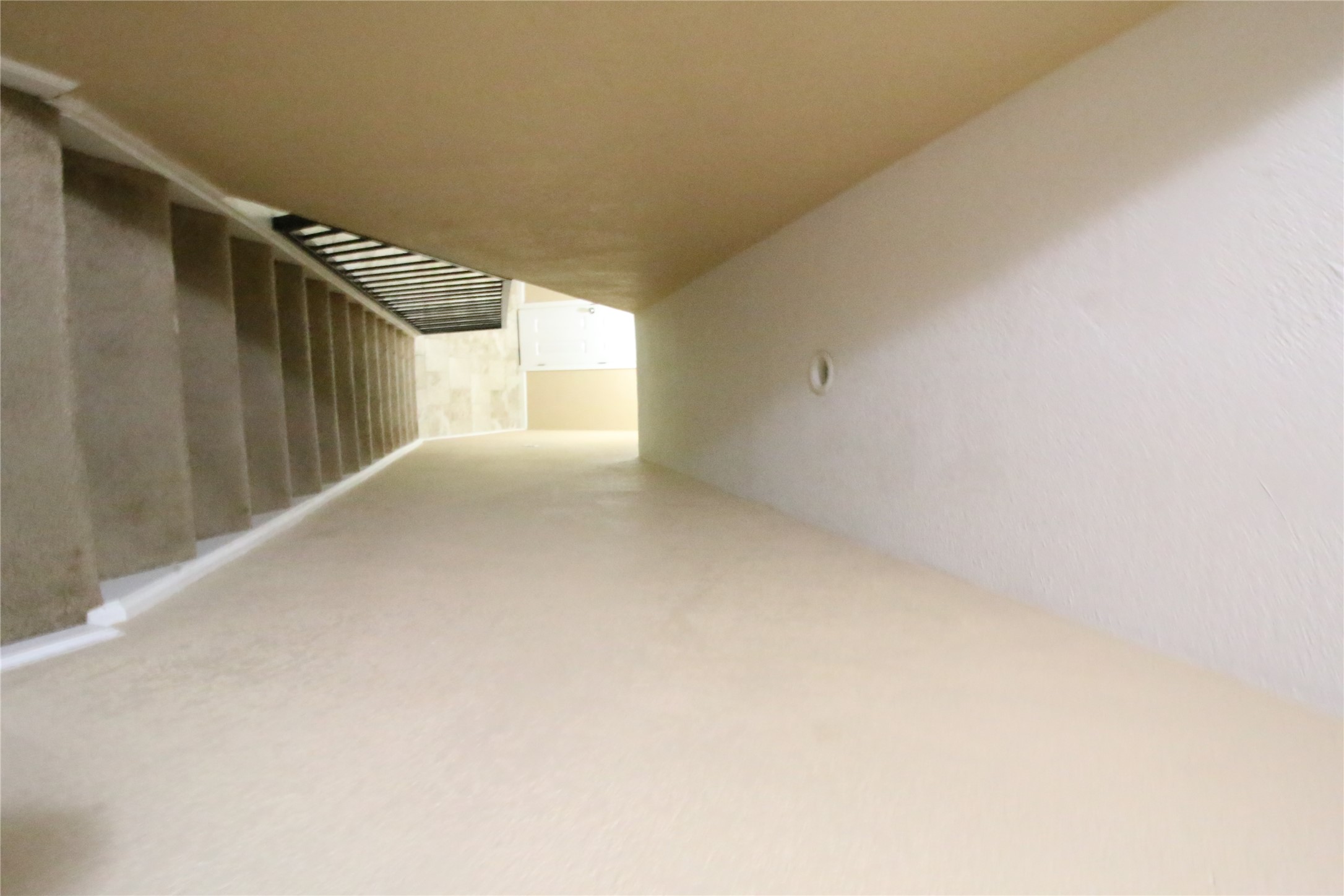 703 Castle Ridge Road, Unit B Austin, TX 78746 - Photo 5 of 5 Carpeted stairs descend to a lower level, illuminated by recessed lighting.