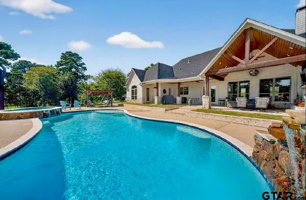 a view of an house with swimming pool and porch