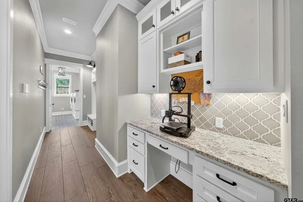 a view of a kitchen cabinets and wooden floor