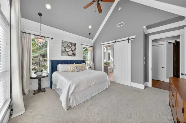 a spacious bedroom with a bed and a walk in closet