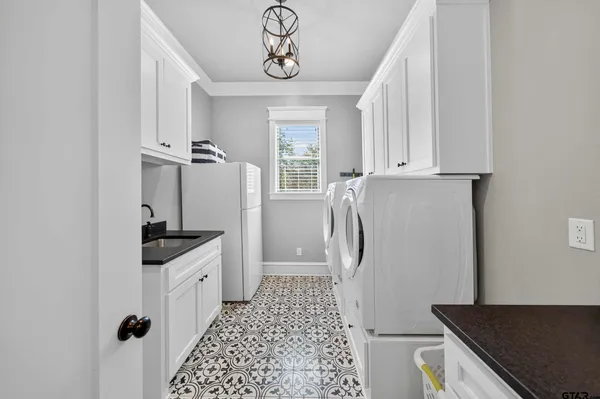 a kitchen with granite countertop a sink a counter space and cabinets