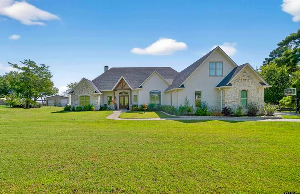 a front view of house with yard and green space