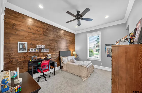 a spacious bedroom with a bed a couch and a walk in closet