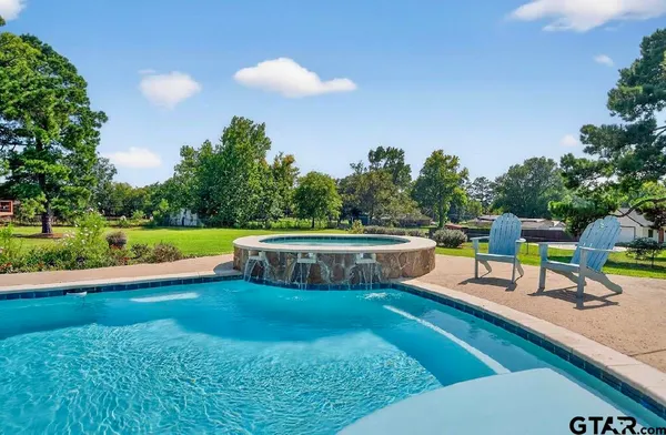 a view of a swimming pool with a patio