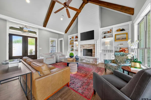 a living room with furniture fireplace and a flat screen tv