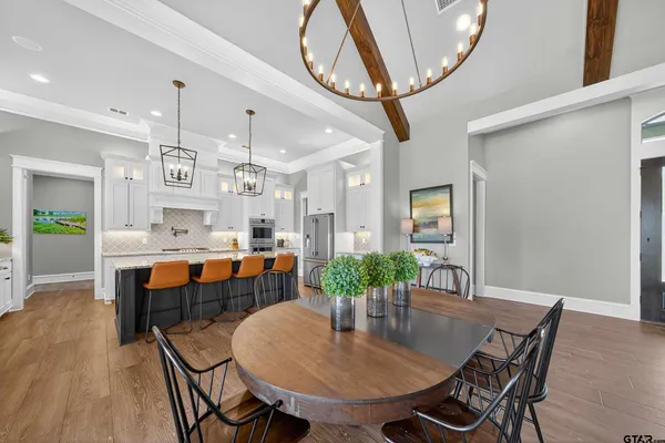 a dining room with furniture a rug and a chandelier