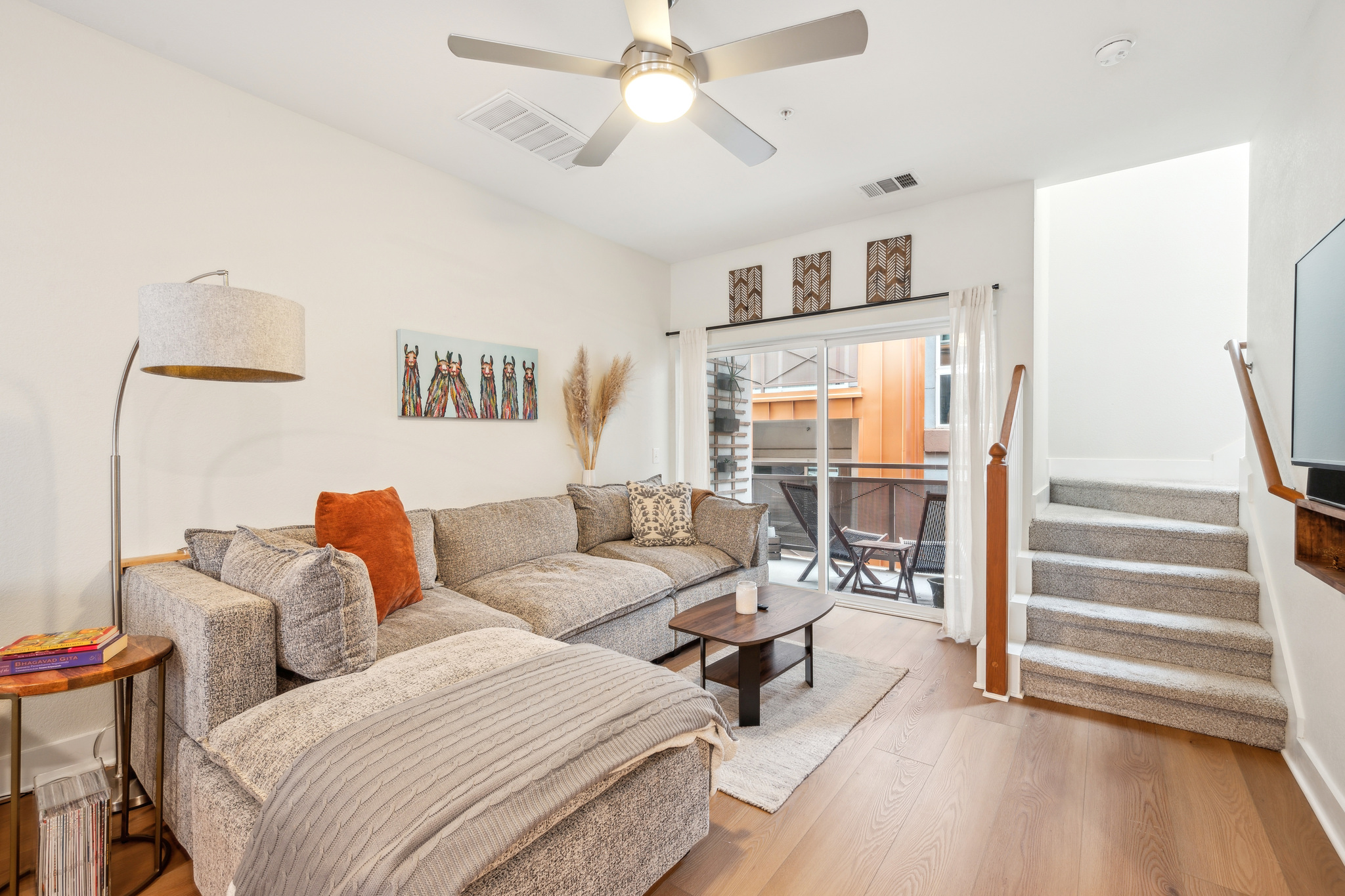 2827 Manor Road, Unit 3104 Austin, TX 78722 - Photo 7 of 30 Hardwood floors and a carpeted staircase create a balanced, inviting living area.