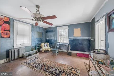 a living room with furniture a rug and a window