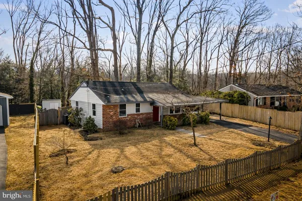a view of a house with a wooden roof and trees
