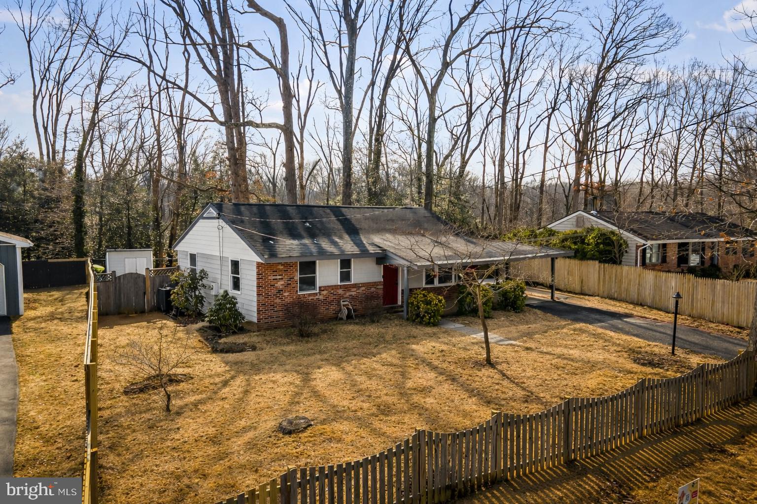 a view of a house with a wooden roof and trees