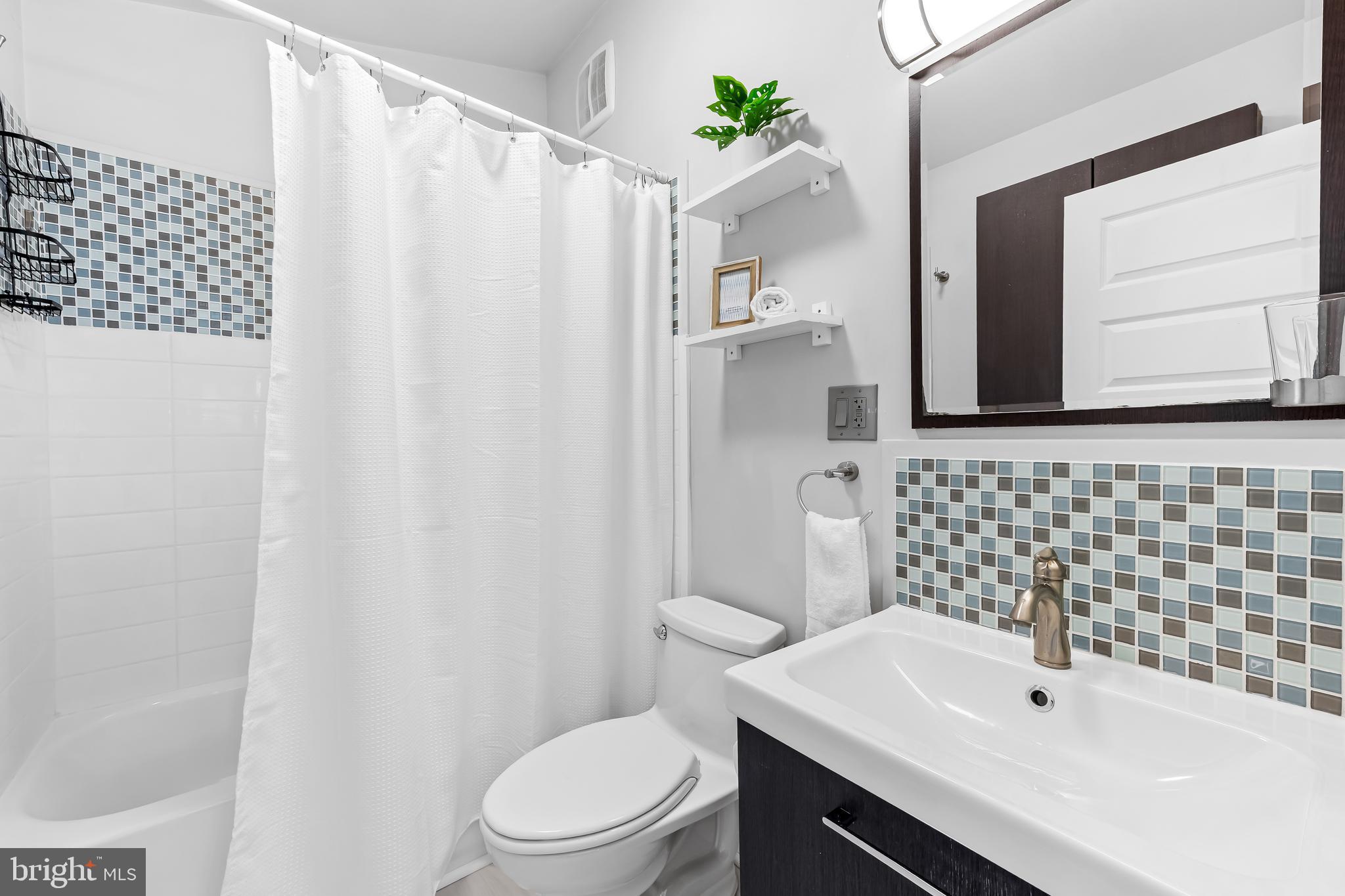 127 Cresston Road Arnold, MD 21012 - Photo 11 of 32 a bathroom with a sink a toilet and shower curtain