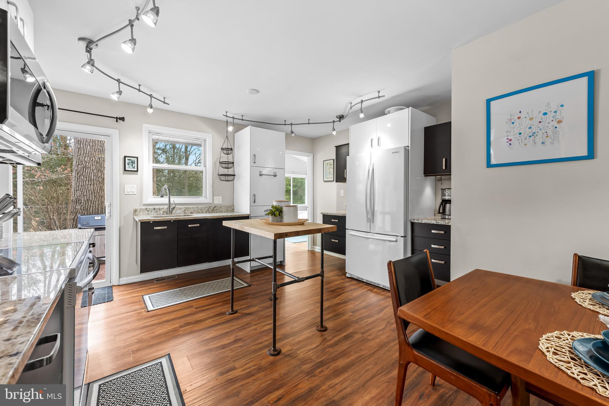 127 Cresston Road Arnold, MD 21012 - Photo 6 of 32 a kitchen with a table chairs refrigerator and cabinets