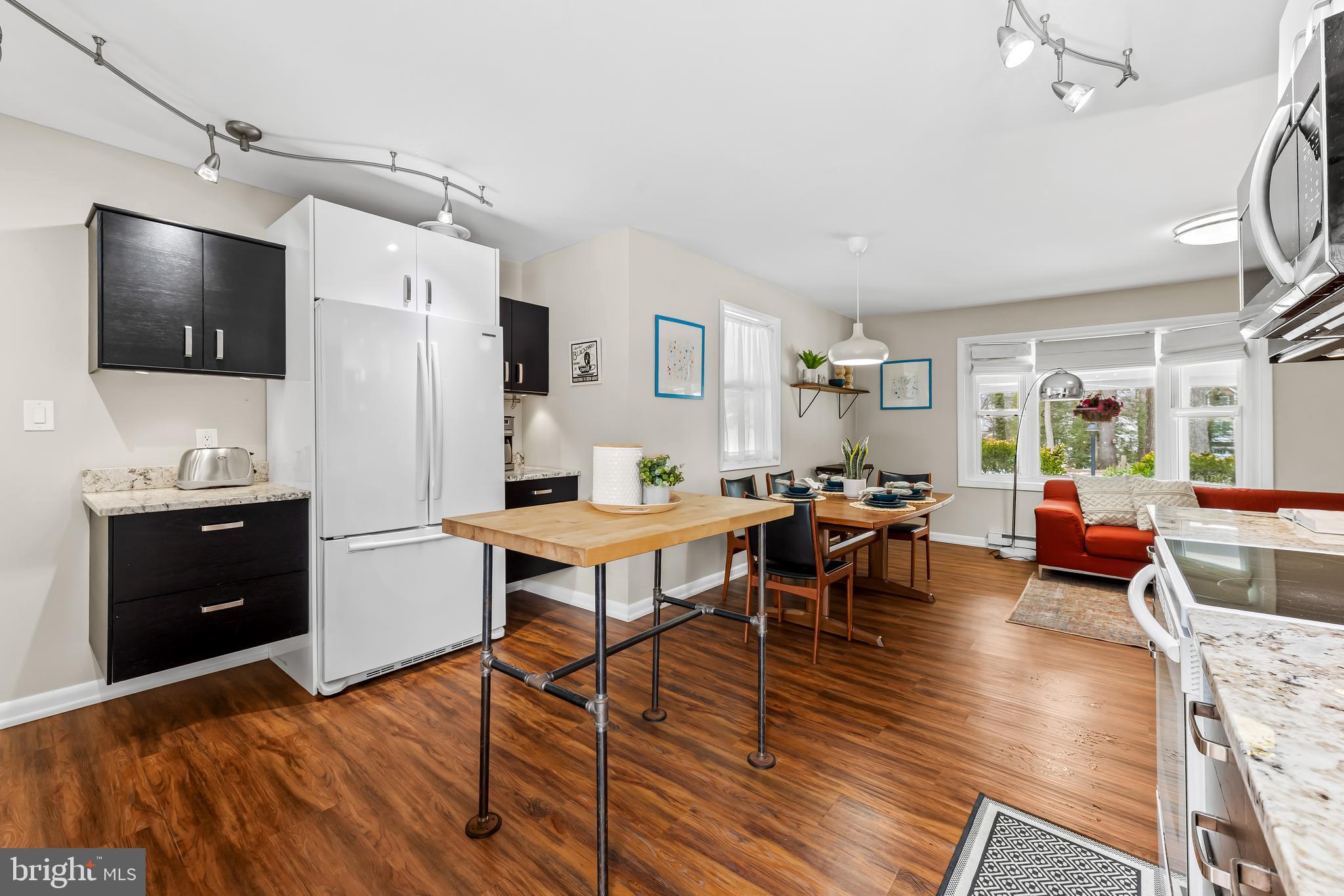 127 Cresston Road Arnold, MD 21012 - Photo 7 of 32 a living room with furniture a flat screen tv and kitchen view