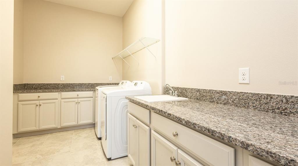 2278 Datura Loop St. Cloud, FL 34772 - Photo 15 of 31 a bathroom with a granite countertop sink and a mirror