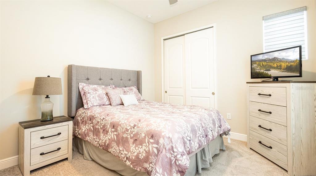 2278 Datura Loop St. Cloud, FL 34772 - Photo 18 of 31 a bedroom with a bed and a flat screen tv
