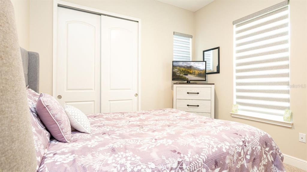2278 Datura Loop St. Cloud, FL 34772 - Photo 19 of 31 a bedroom with a large bed and a window