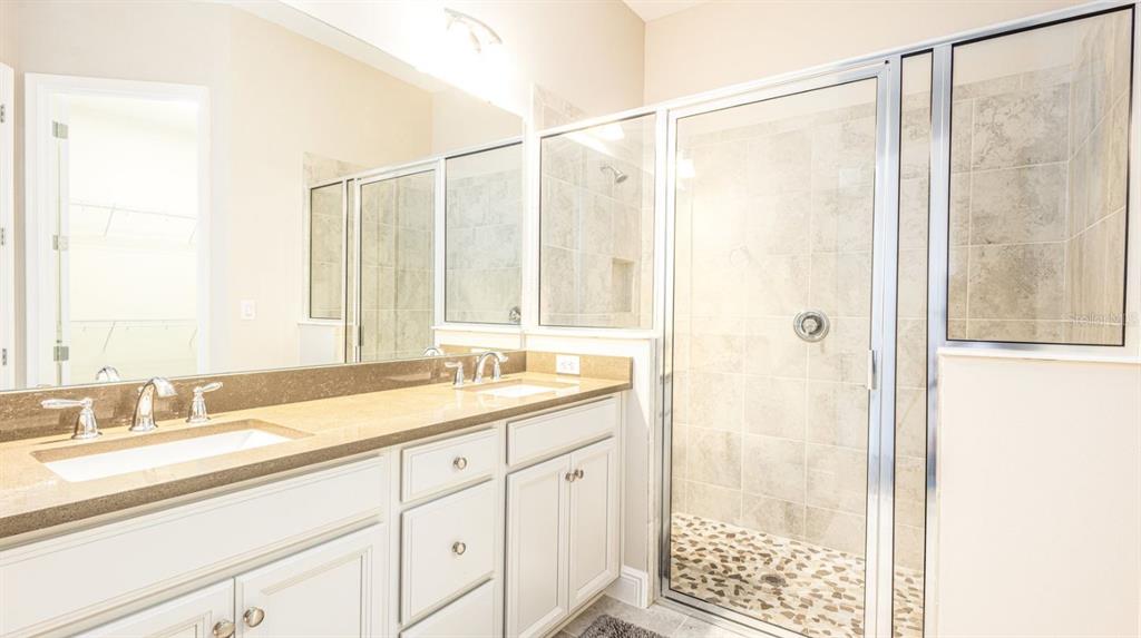 2278 Datura Loop St. Cloud, FL 34772 - Photo 20 of 31 a bathroom with a double vanity sink and a shower